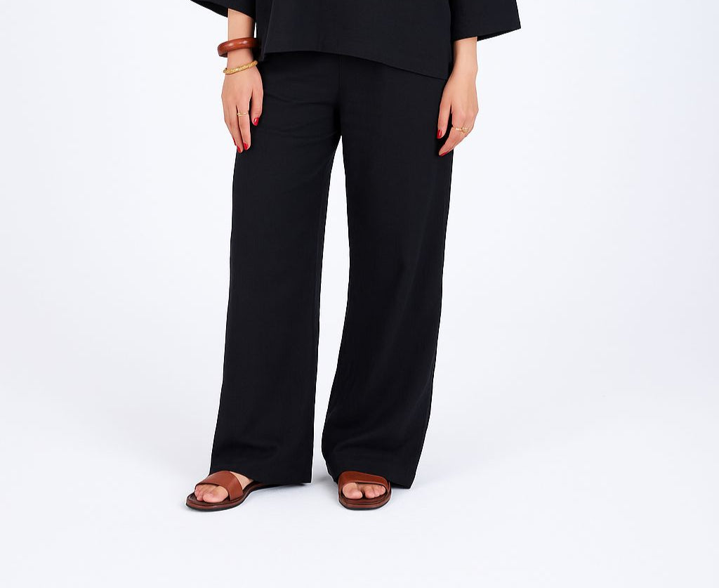 Woman wearing a black outfit on a white background